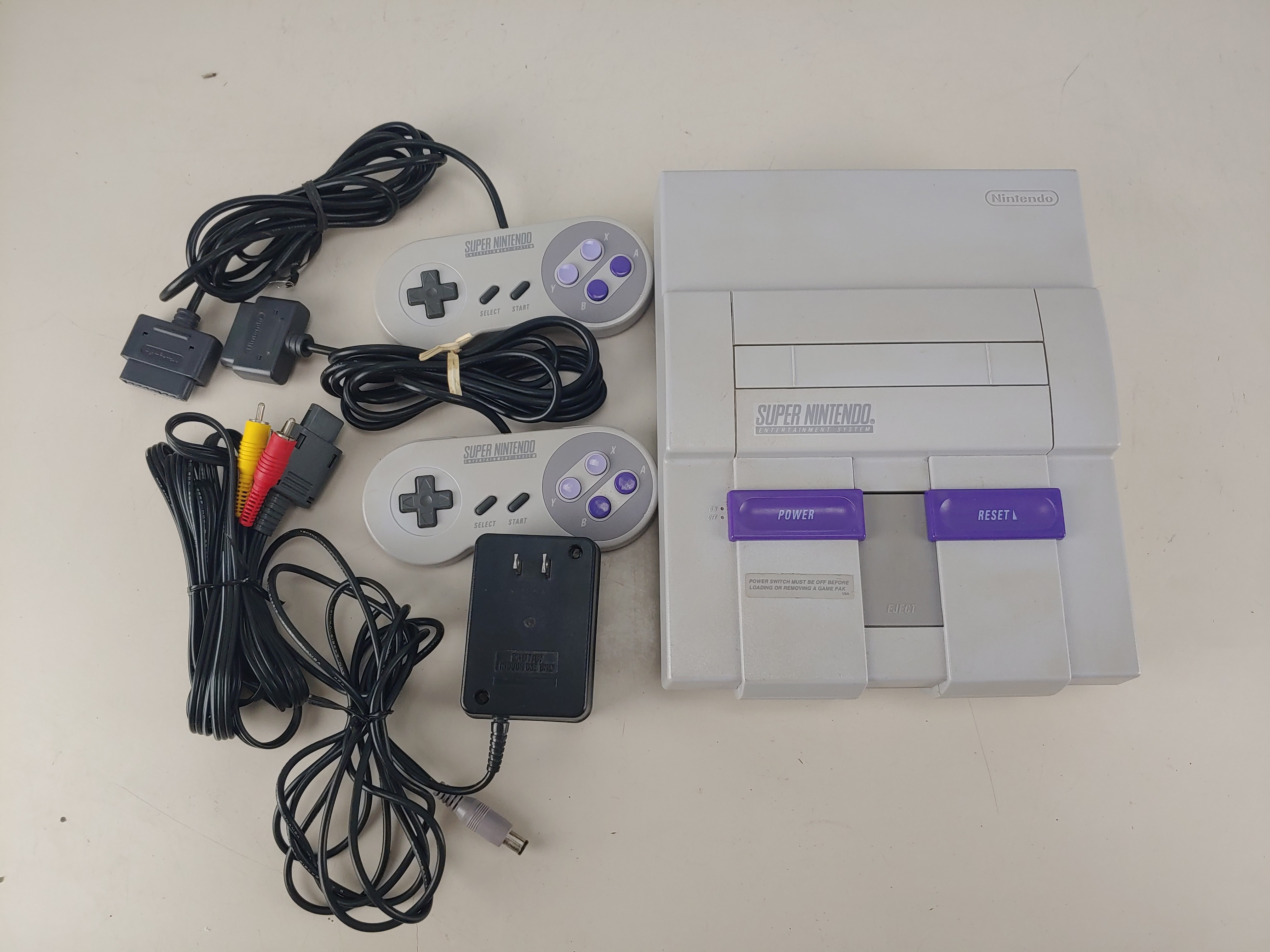 USED and Tested Super Nintendo Console with AC Adapter, RCA Cable, 2 SNES Controllers, and Instruction Booklet
